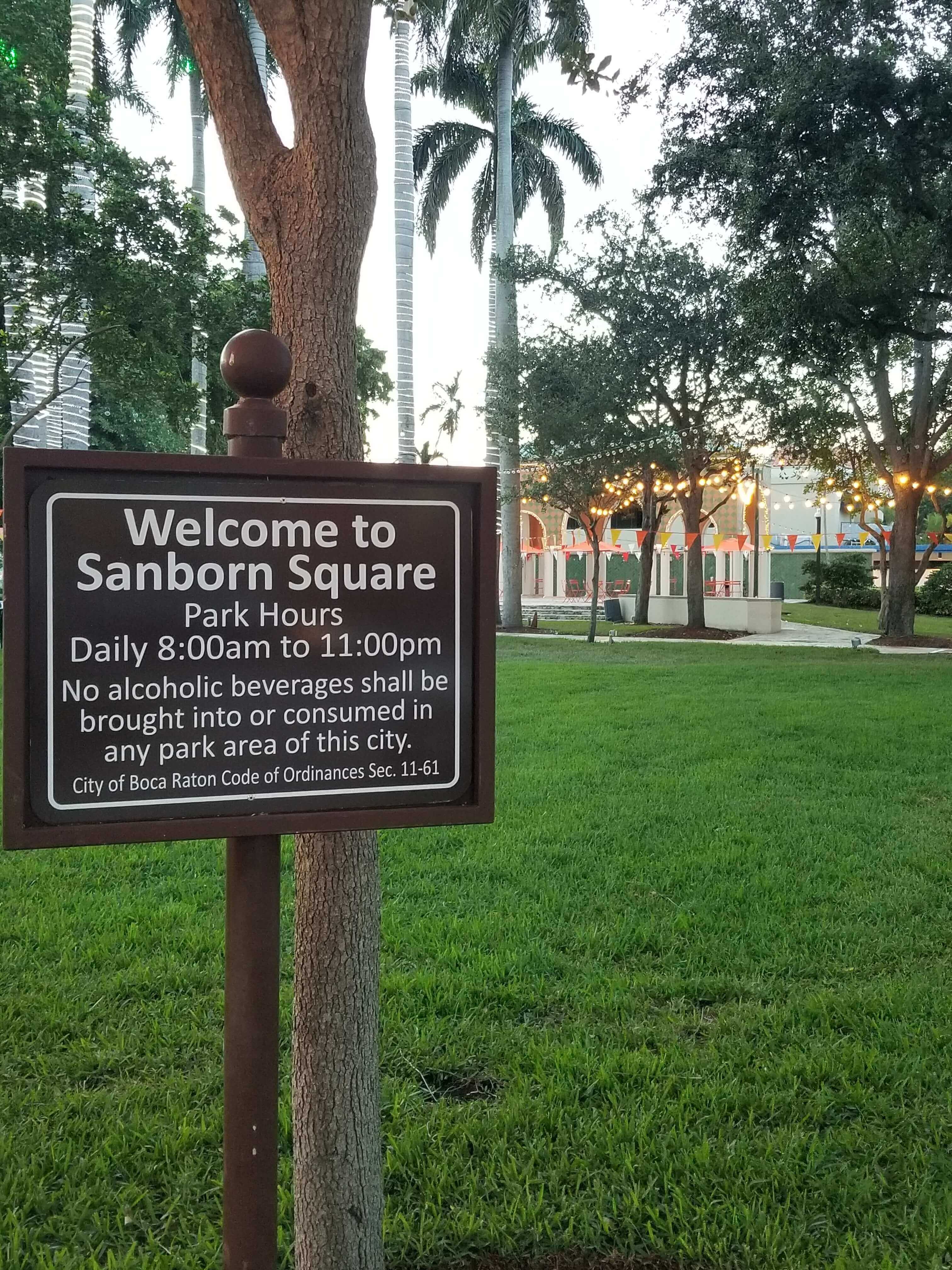Sanborn Square Park at dusk with string lights and pavilion glowing